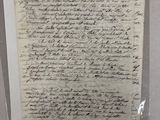 une feuille de papier avec une écriture dessus, posée sur une table