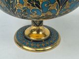an image of a blue and gold bowl on a white surface