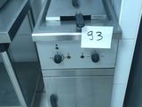 a silver stove with a sign on it in a kitchen