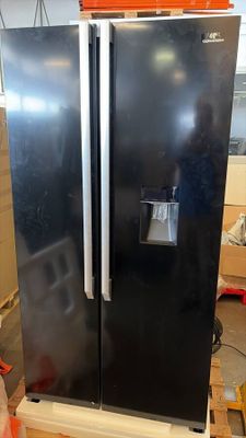 a black refrigerator sitting on a pallet in a warehouse