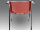 a red plastic chair with metal legs and a black frame