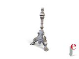 a silver candle holder on a white background with the eiffel tower in the background