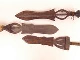 two old wooden knifes are sitting next to each other on a white surface