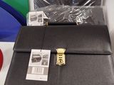 a black briefcase sitting on a table next to a pair of scissors