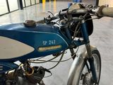 a blue and white motorcycle parked inside of a building