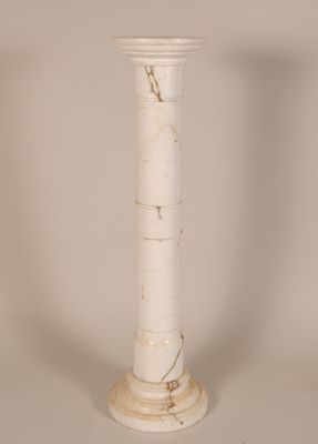 a white marble pedestal with a marble column on top of it