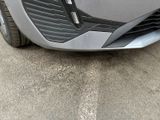 a close up of a car ' s front bumper with the door open