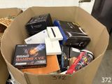 a cardboard box full of books and other electronic equipment
