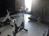 an image of a gym room with stationary exercise bikes