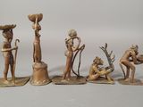 five figurines of different people with a bowl on their head