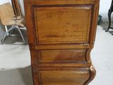 a tall wooden dresser with a mirror on top of it