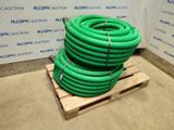 a pile of green hoses sitting on a pallet