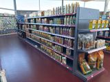 many shelves in the store with various foods on them