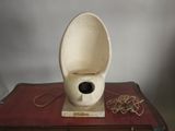 une cuvette de WC blanche posée sur un livre rouge