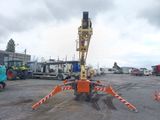 a crane that is sitting in the middle of a parking lot