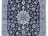 a blue and white rug with a medallion design on it