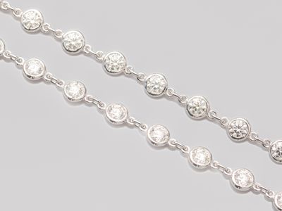 a close up of a chain of diamonds on a gray surface