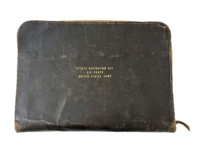 an old book with writing on it sitting on a white surface