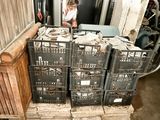 a woman that is standing in front of a stack of crates