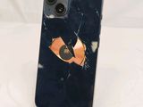 an iphone with a broken screen sitting on top of a table