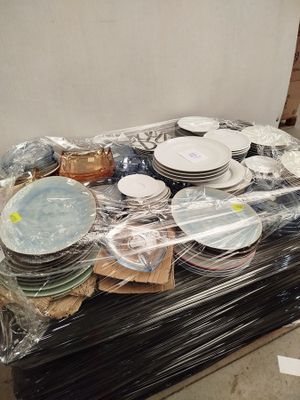 a lot of plates and bowls sitting on a table