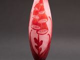 a glass vase with a red and white design on it