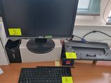 a computer monitor sitting on a desk with a keyboard and mouse