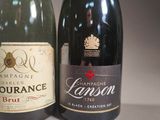 two bottles of champagne sitting next to each other on a table