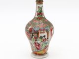 a small vase with a painting on it sitting on a white surface