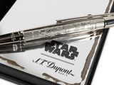 the pen is sitting on top of a piece of paper with a star wars logo on it