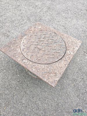 a manhole cover on the ground on the street