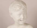 marble bust of a young boy with a smile on his face