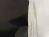 a box that has a laptop in it on a bed
