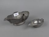 two silverware items, one with a spoon and the other with a spoon in it