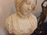 a statue of a woman that is sitting on a table