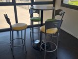 tables and chairs in a room with a view of the mountains
