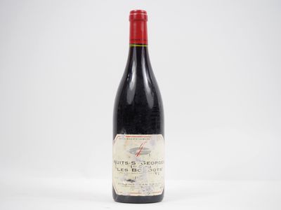 a bottle of red wine sitting on top of a white table