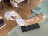 a glass table with a sculpture of a duck on it
