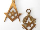 two masonic symbols are shown on a white surface