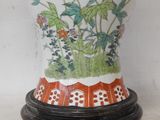 a vase that has flowers on it on a stand