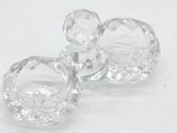 two clear glass knobs on a white surface
