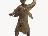 bronze figurine of a man with a hat on his head