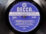 vinyl record with a blue label on it sitting on top of a table
