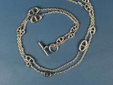 a close up of a chain with a clasp on a blue surface
