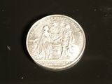 a silver coin with a picture of a man and a woman on it