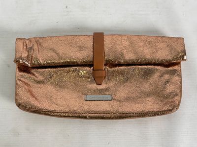 a close up of a purse on a table with a white background