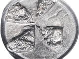 a close up of a silver coin with a cross on it