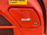 a sign on the front of a red tractor