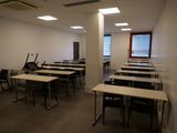 de nombreuses tables et chaises dans une pièce dotée d'une fenêtre