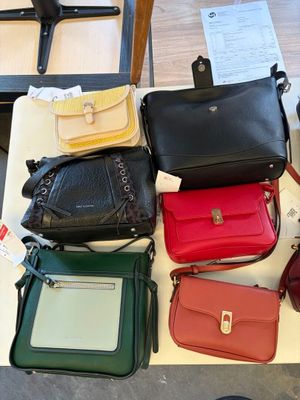 a lot of purses that are on a table